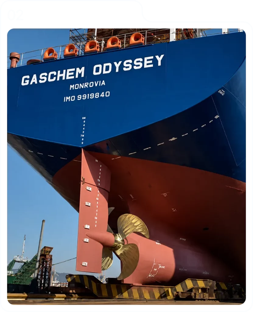 Rudder and propeller under the stern of a vessel at the quay